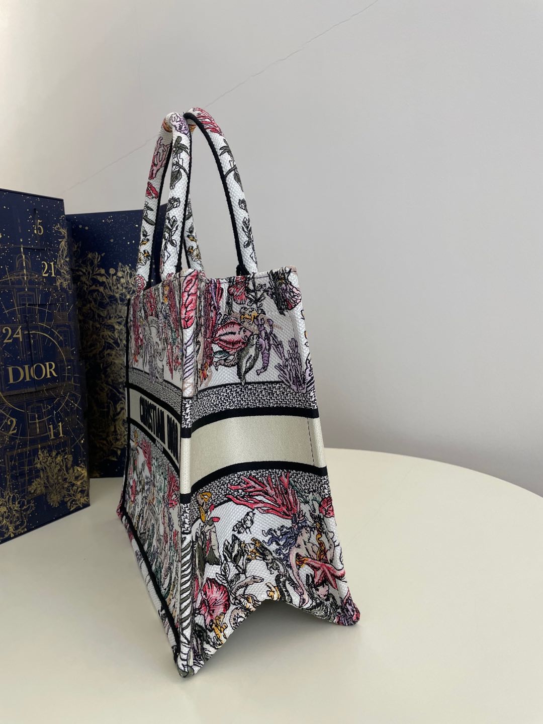Bagsaaa Medium D10r Book Tote Latte Embroidery with Multicolor D10r Cabinet de la Mer Motif - 36 x 27.5 x 16.5 cm